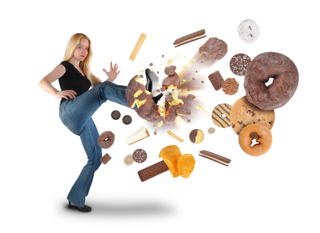 woman kicking fatty foods away from her